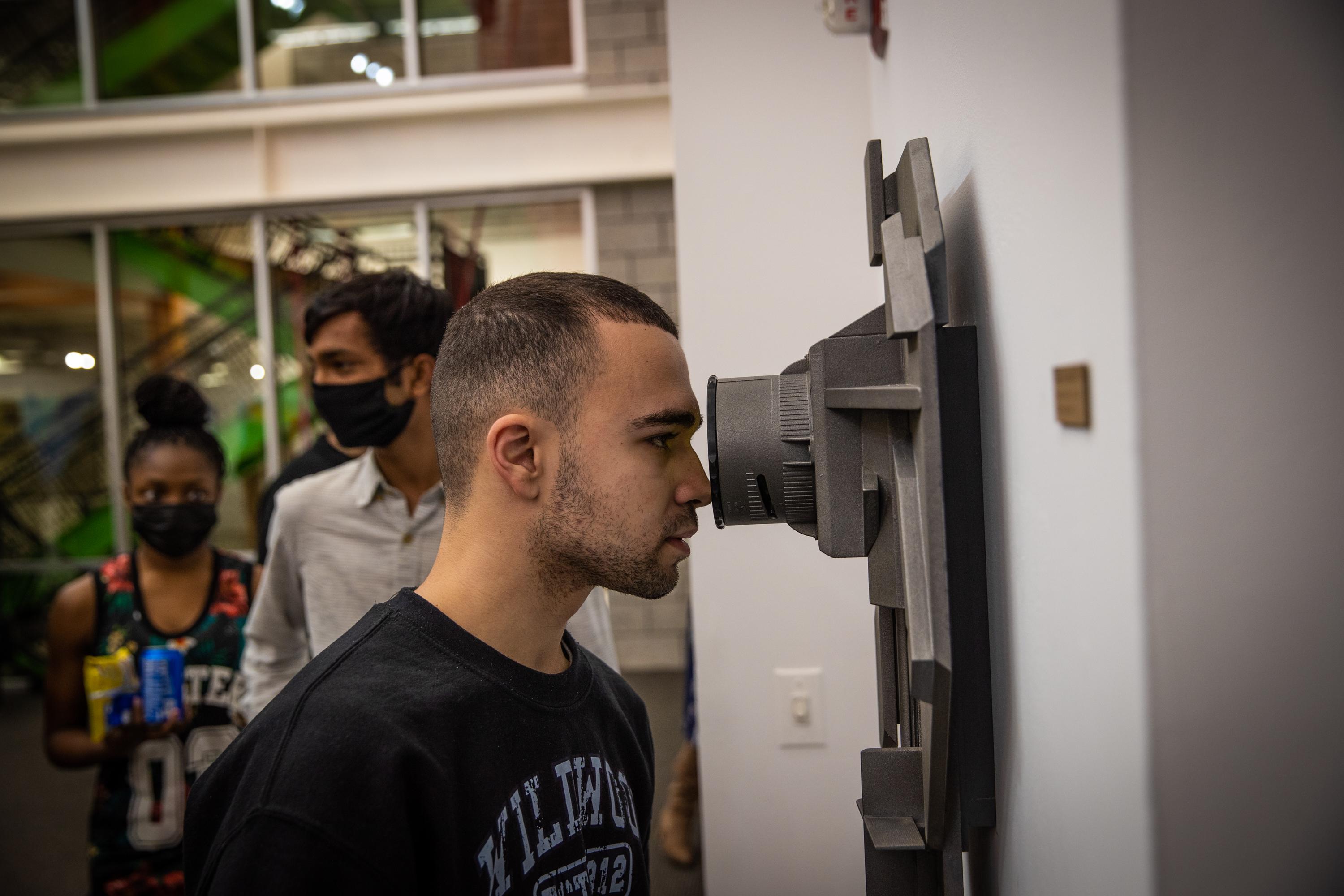 Julian Santiago ’25 viewing Bianchino’s Transportal #4 Emerald