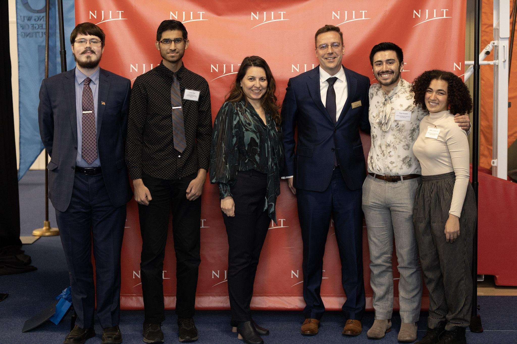 Associate Dean Burcak Ozludil and Dean Louis Hamilton are flanked by award-winners (left to right) Michael Tuma, Umair Kahn, Noah Roselli and Jada Evans.