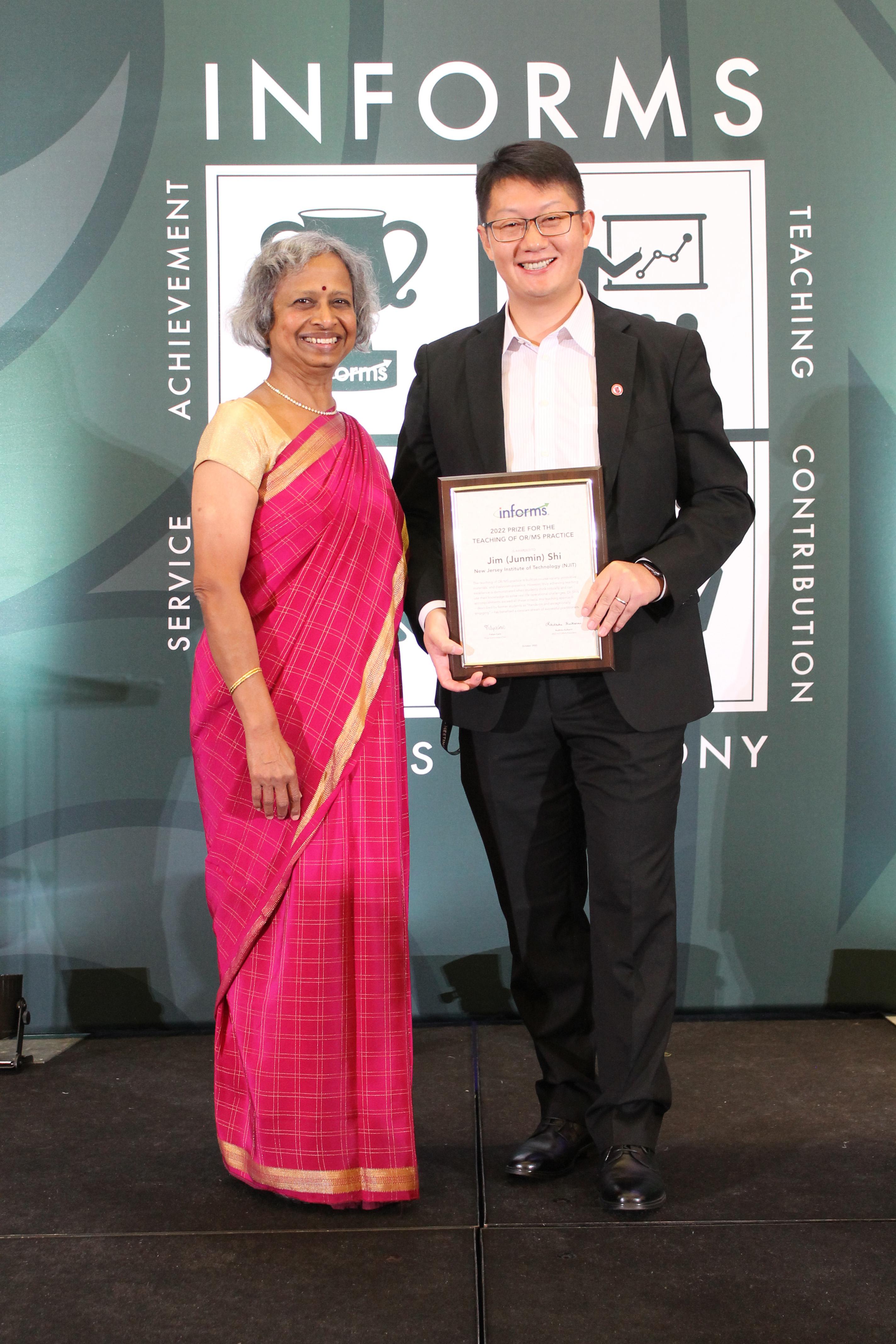Shi (right) received his award at the INFORMS conference