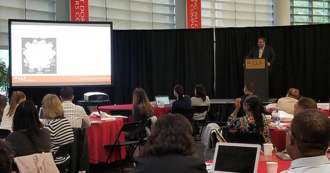Forensic science professor, David Fisher, addresses the crowd at Pre-College's STEM Forum.
